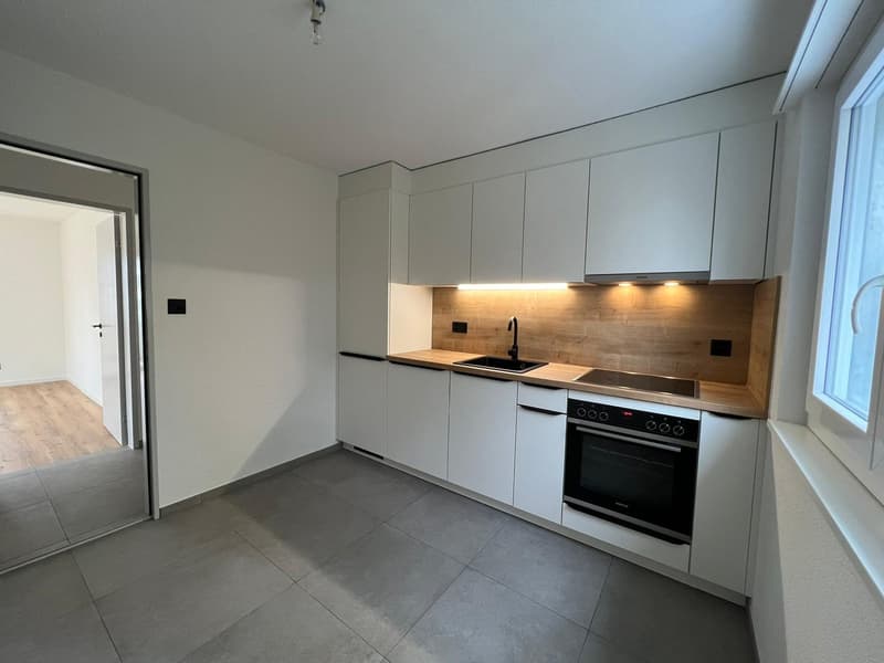 modern design, white cabinets, wooden countertops, built-in oven and dishwasher, tiled floor, sink with faucet, glass window