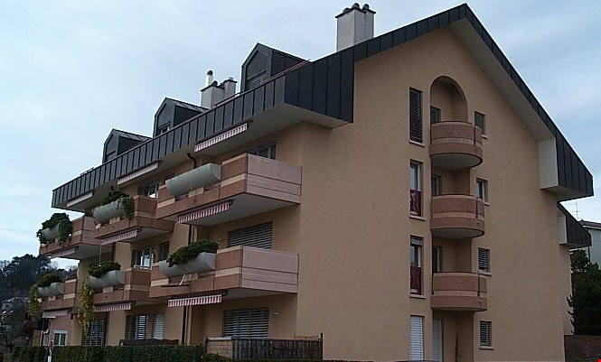 Apartment building, multiple floors, balconies, beige facade, chimneys