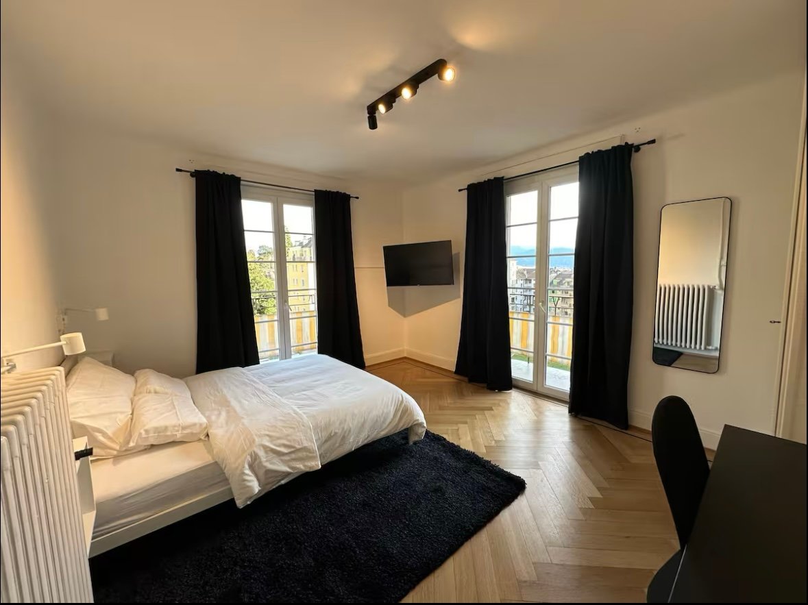 Large bed, double curtains, balcony, built-in TV, radiator, dark rug, white radiators