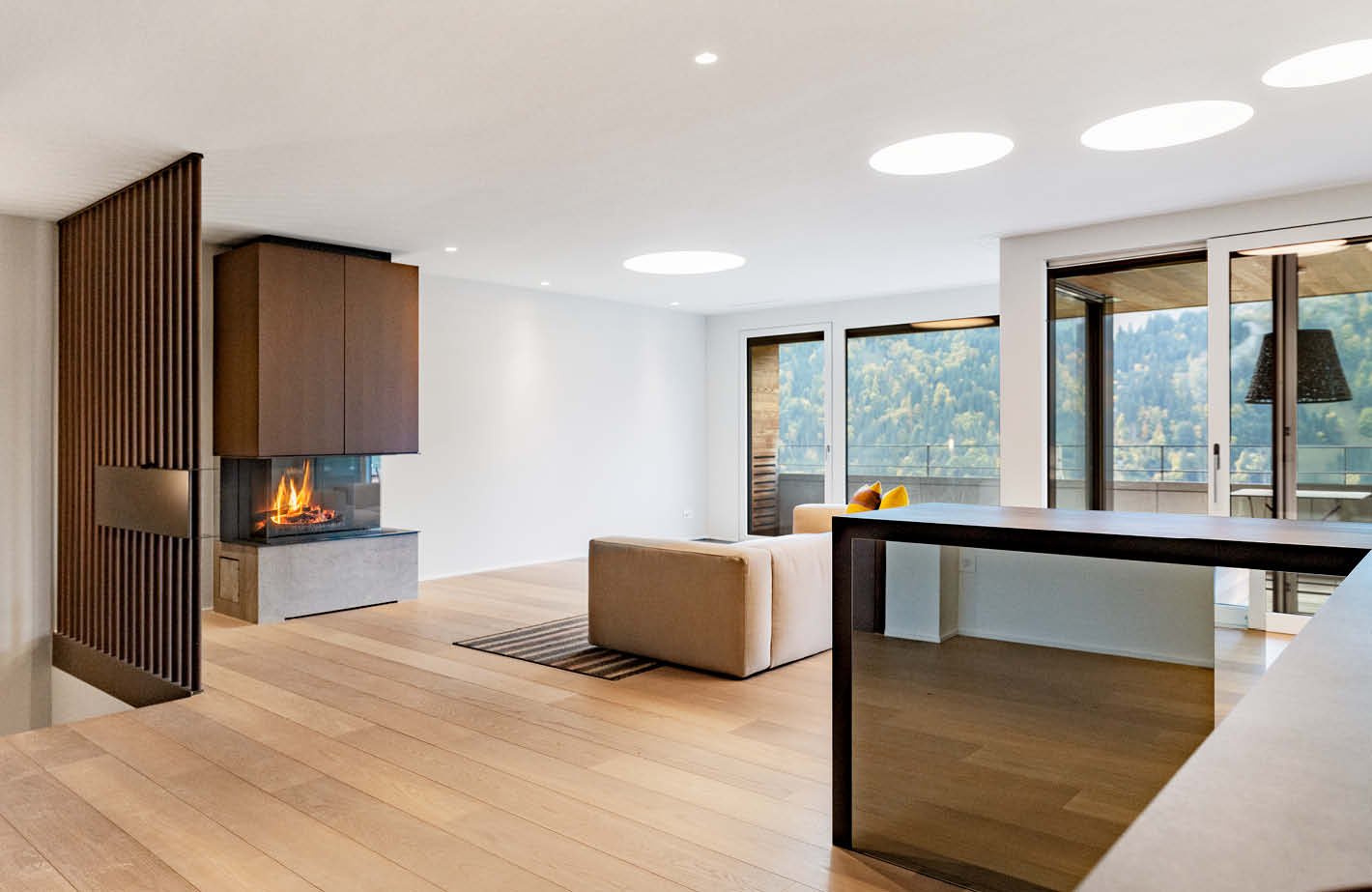 modern fireplace, beige couch, dining table, wooden floor, sliding doors, sliding balcony doors, mountain view