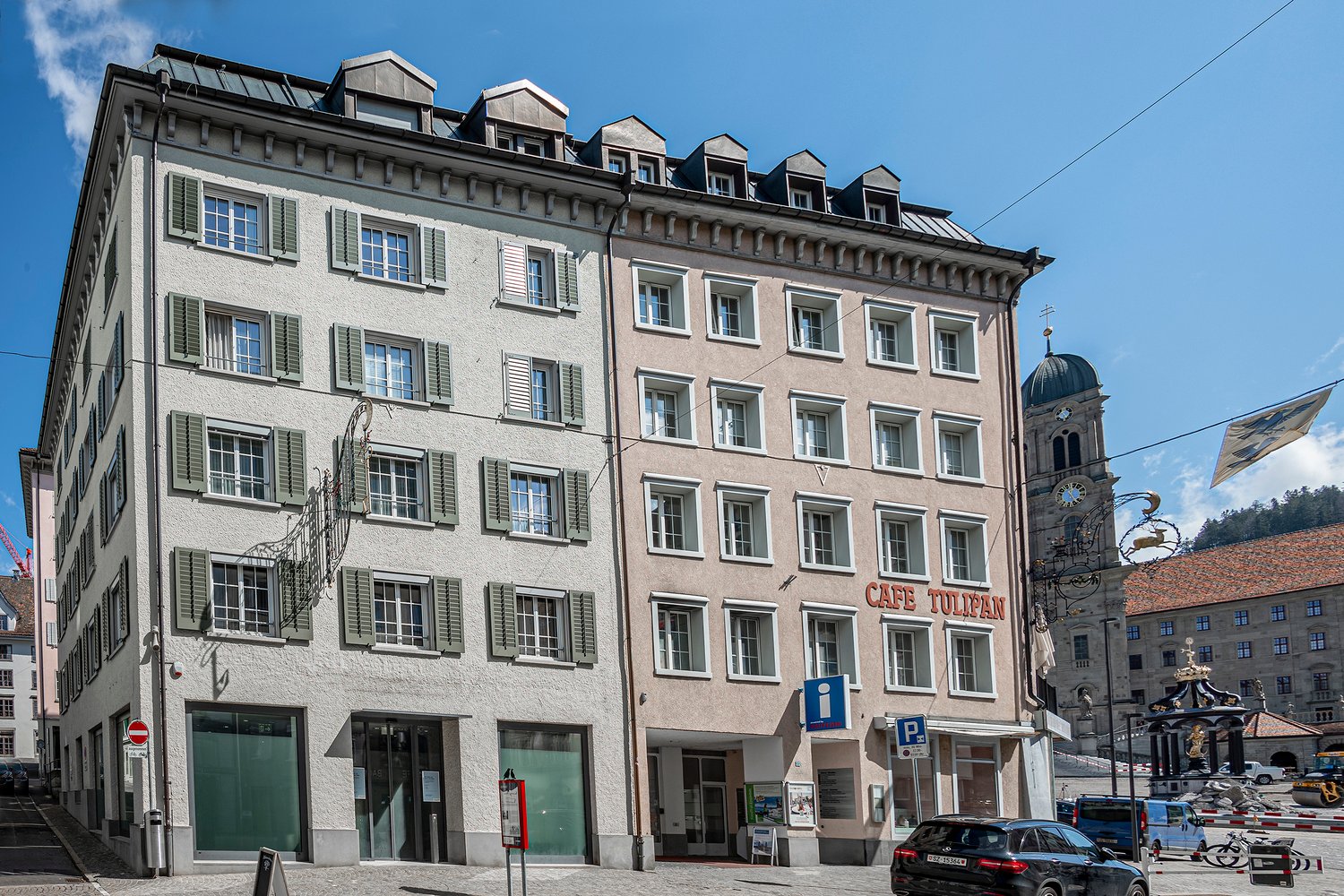 multi-storey building with many windows, signboard on the wall