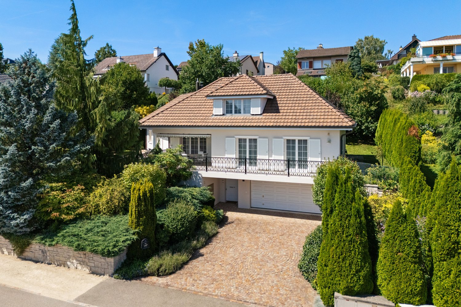 2 story house, brown roof, white walls, balcony, garage, driveway