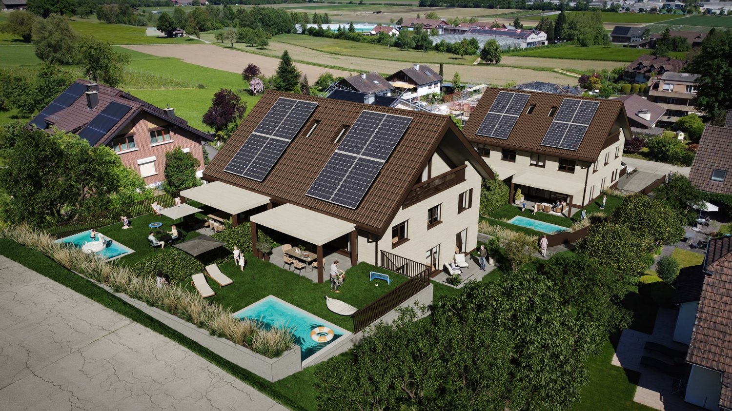 Large multi-story house with solar panels on the roof, surrounded by a well-maintained garden with a swimming pool and outdoor seating areas. The house is situated in a rural, scenic area with green fields and trees in the background.