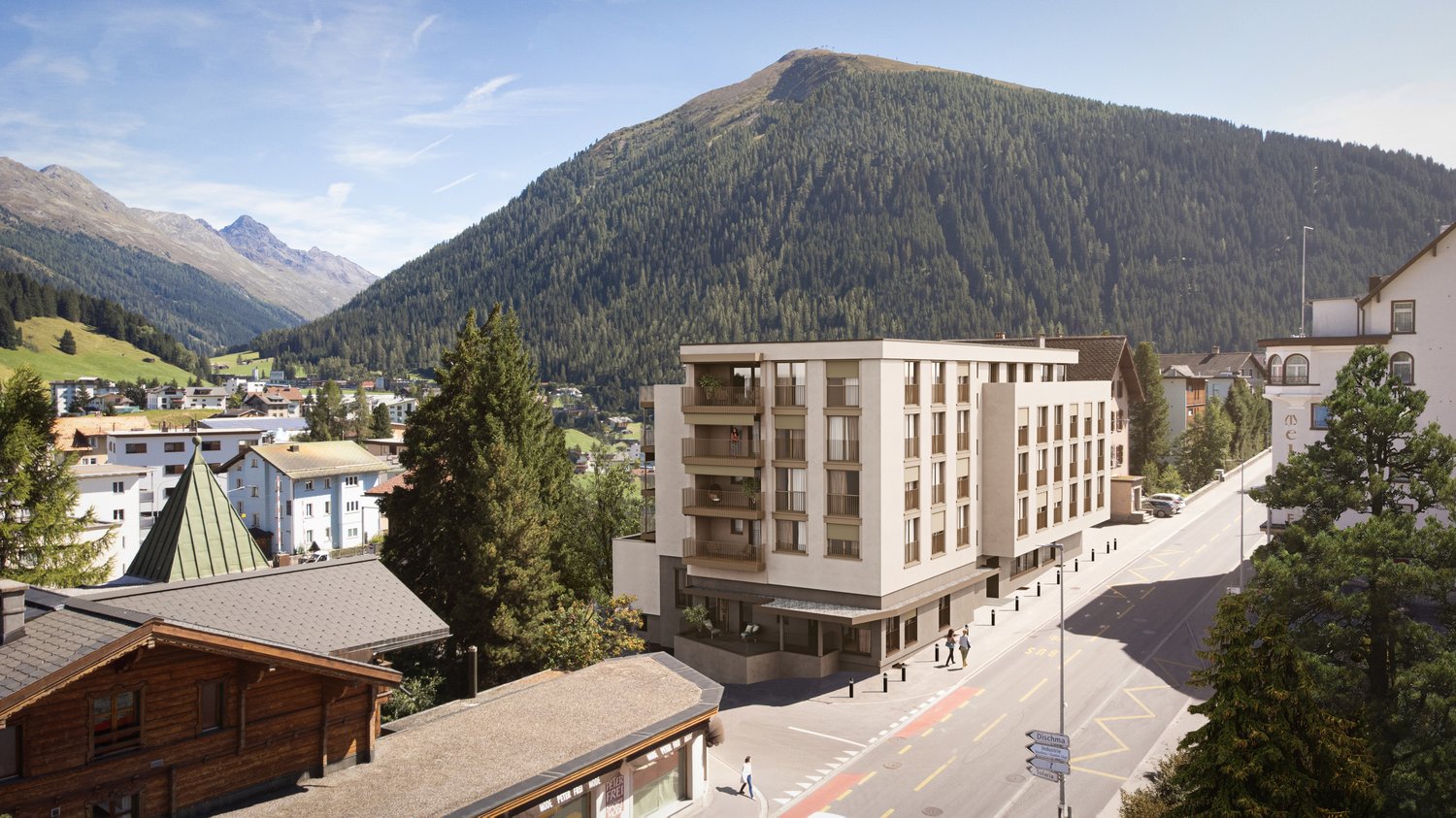A modern apartment building with several balconies, set in a scenic mountainous region.