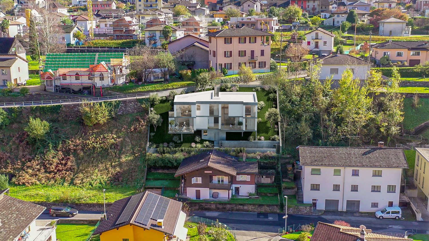 House in a hilly area, near other houses, with a clear view of the landscape.