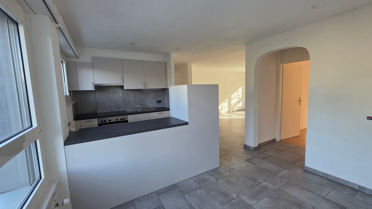 kitchen with island, sink, oven, cabinets, window, modern design, view outside
