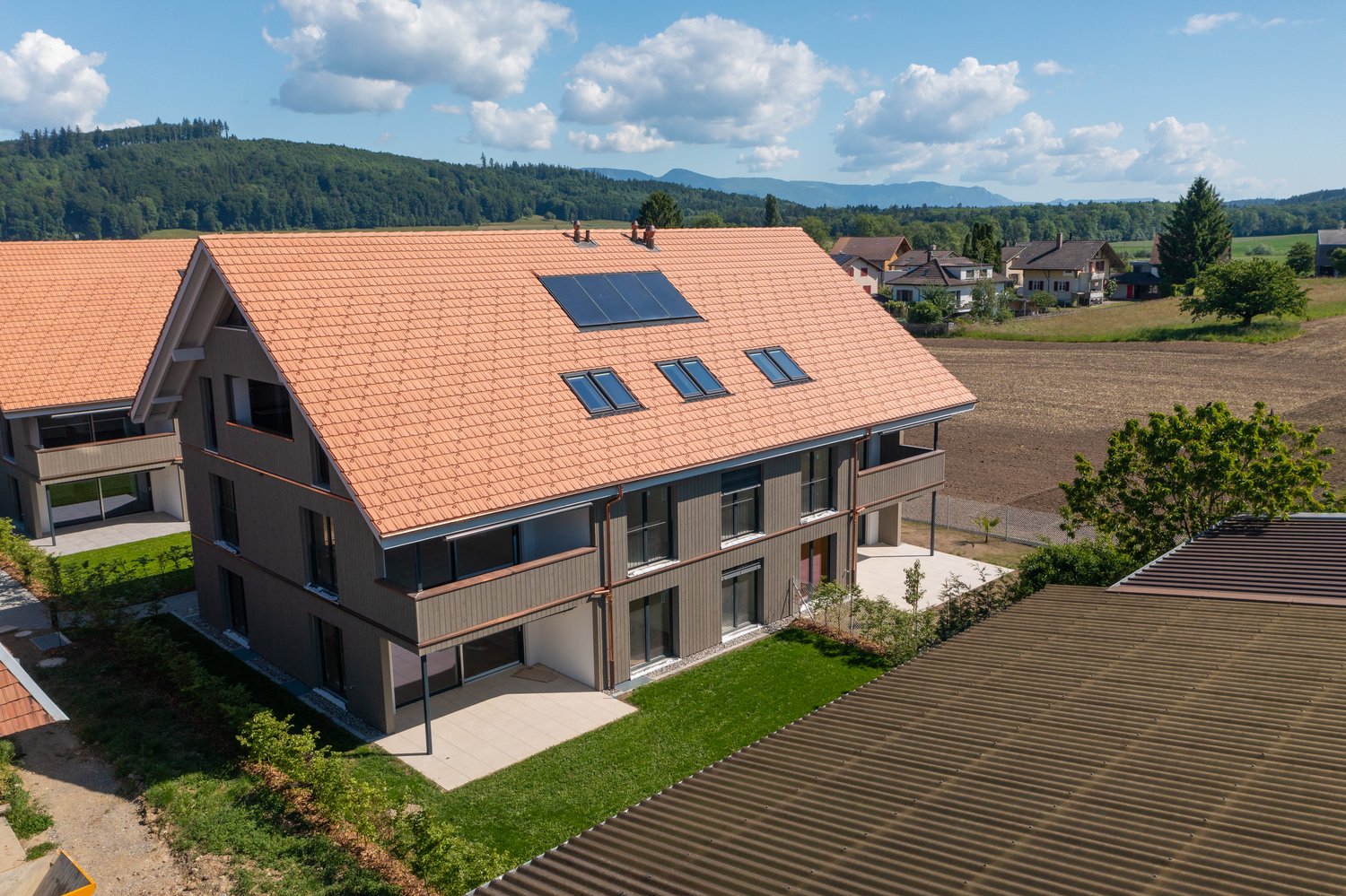 modern house, brown roof, solar panels, chimney, paved entrance, modern architecture