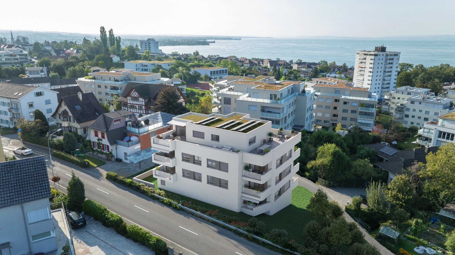 Modern apartment building with green roofs, balconies, and sea view