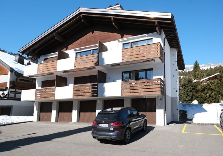 2 story house, white and brown, 3 garages, balcony, snow on the ground