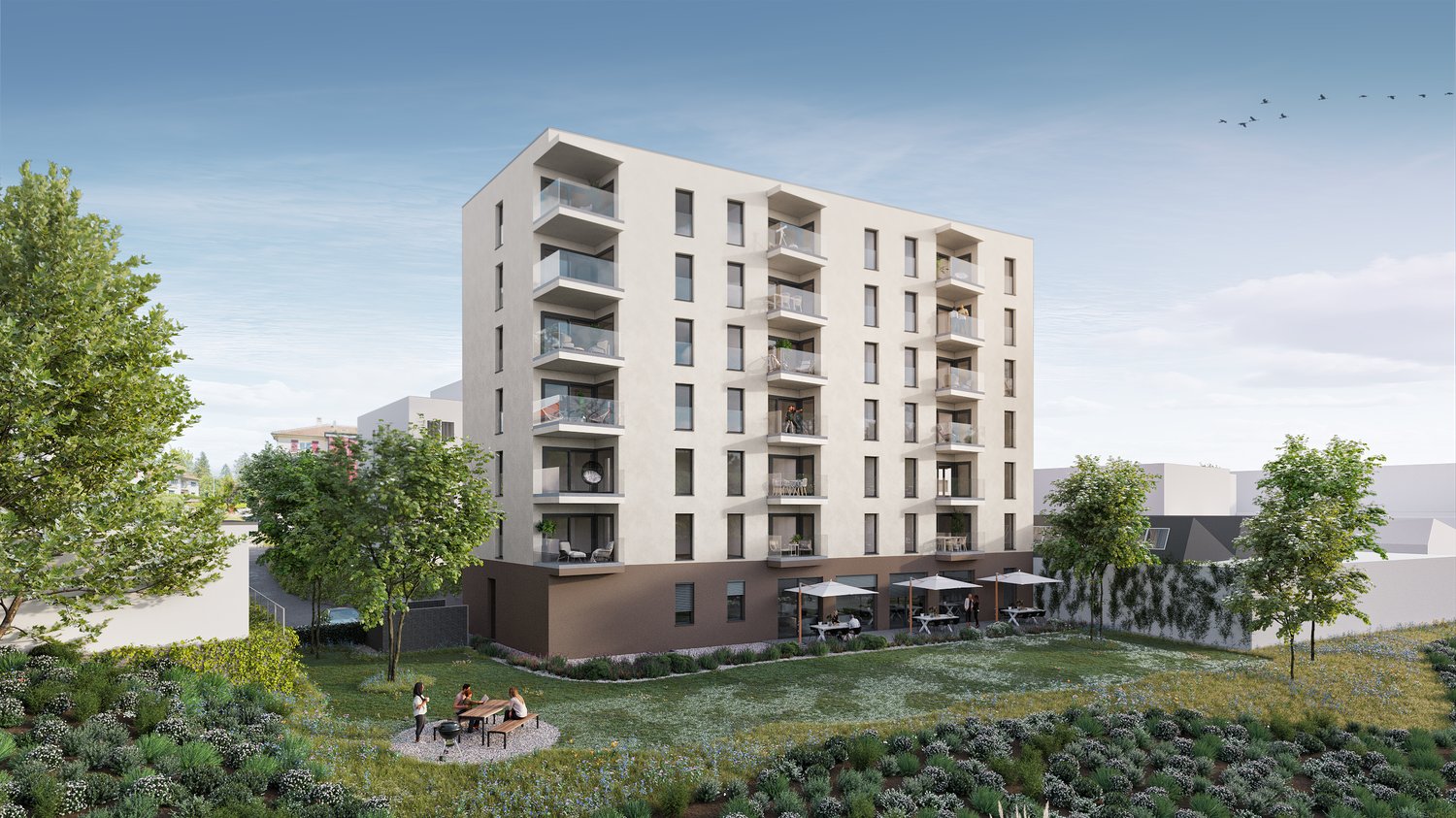 White high-rise building with balconies, garden, and picnic area