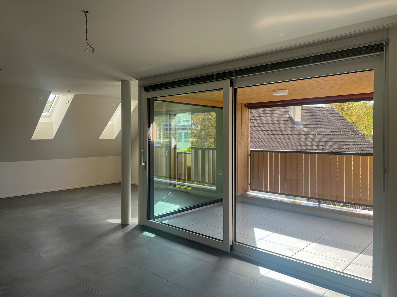sliding doors, tiled floor, balcony with wooden railing, attic windows