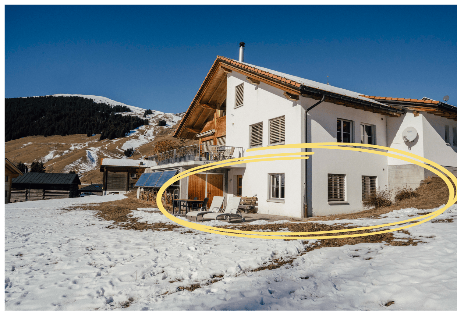 2 story house, white exterior, brown roof, balcony, solar panels, snow-covered ground