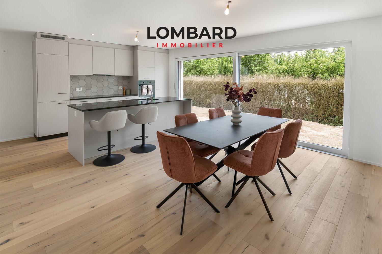 Open kitchen, dining area, light wooden floor, large glass door, outdoor view