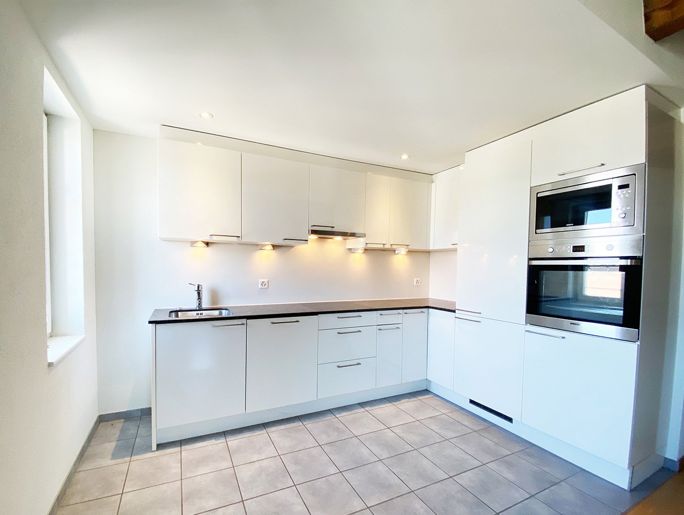 modern kitchen with white cabinets, stainless steel appliances, sink with modern faucet, tiled floor, recessed lighting