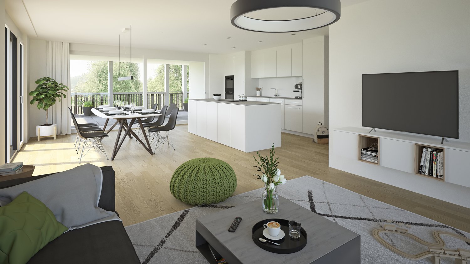 The image shows an open concept living room and kitchen area with large windows providing a view of the outdoors. The kitchen features white cabinets and a central island, while the living room has a gray sofa, a coffee table, and a TV stand. The dining a