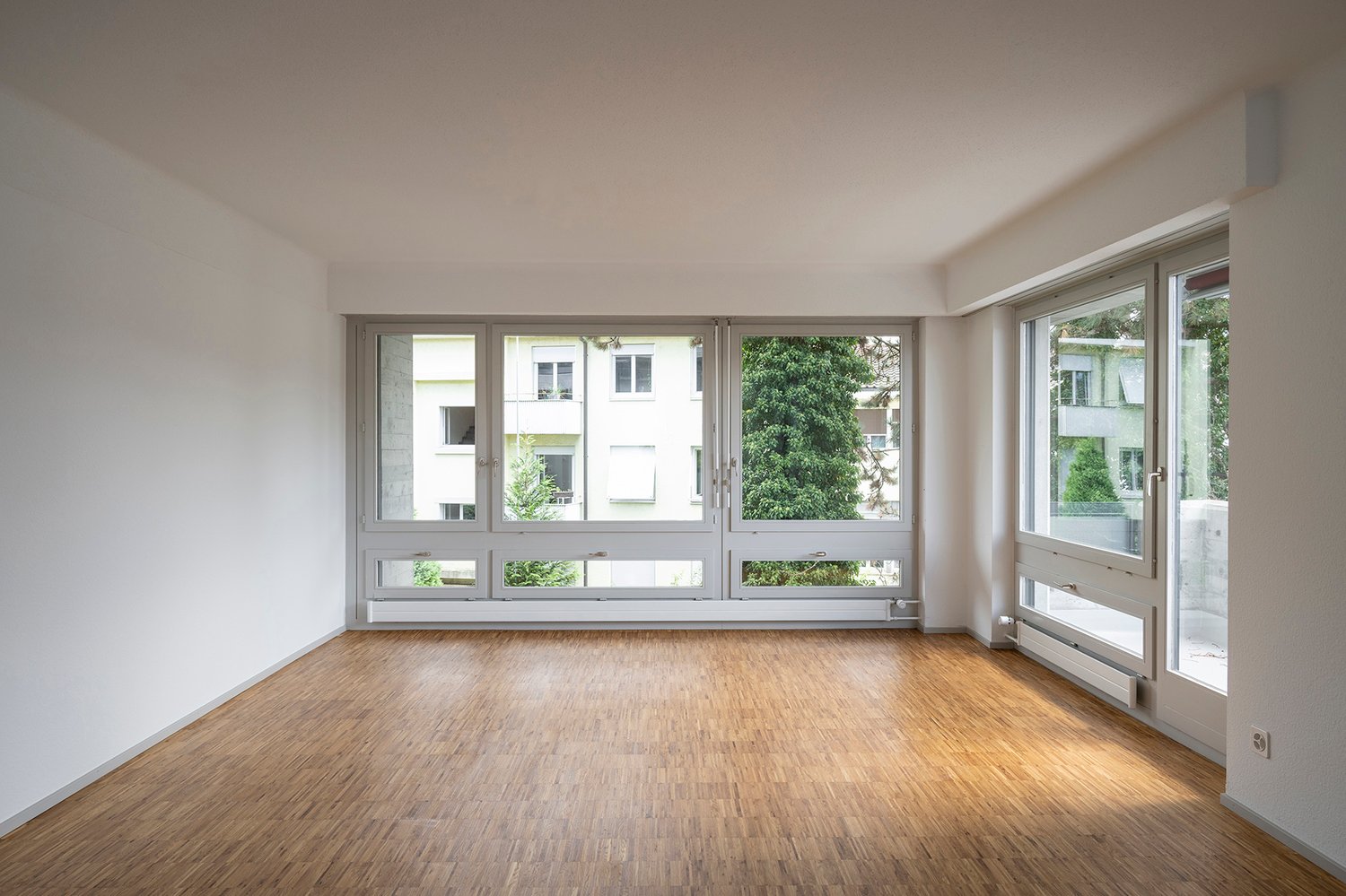 large windows, hardwood floor, empty room
