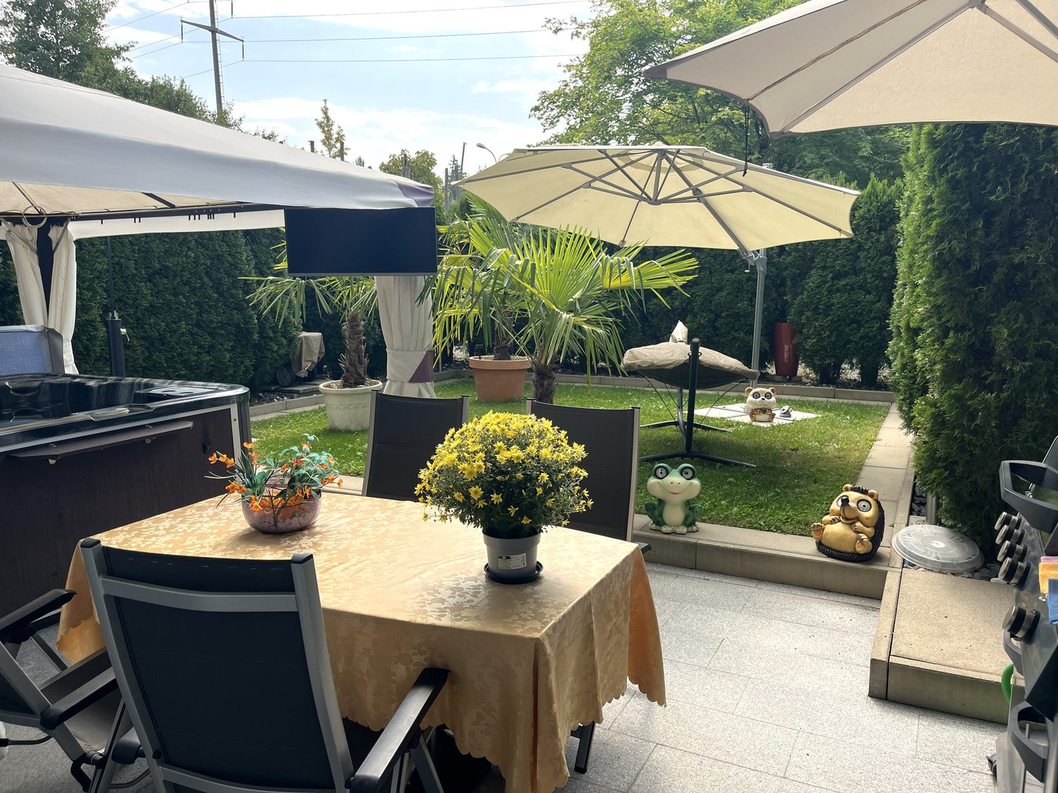 table, chairs, umbrellas, plants, hot tub, garden decorations