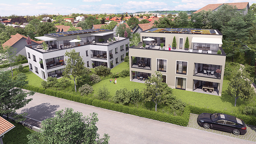 Two multi-story apartment buildings with balconies, surrounded by greenery and trees. Parking spaces are visible in the foreground.