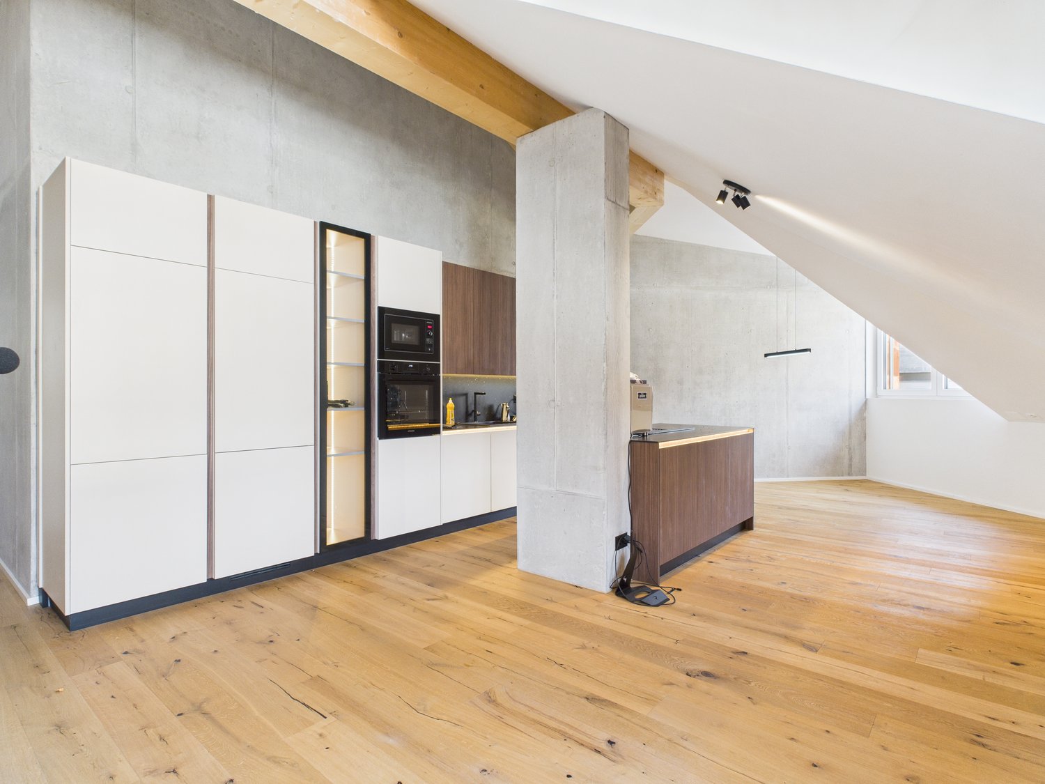 kitchen area with modern cabinets, hardwood floors, and built-in appliances