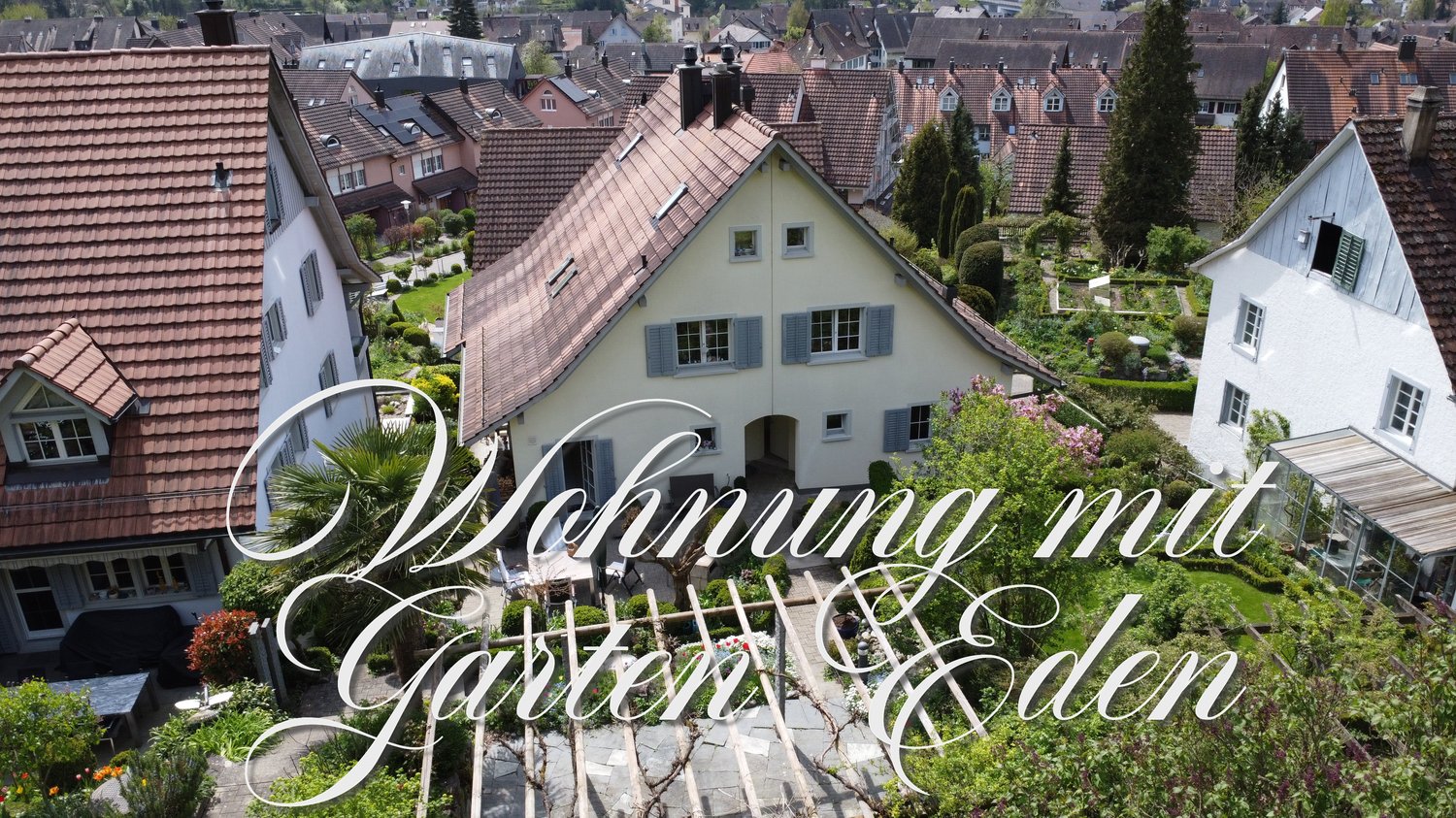 House with garden, multiple houses in the background, trees, plants, and flowers