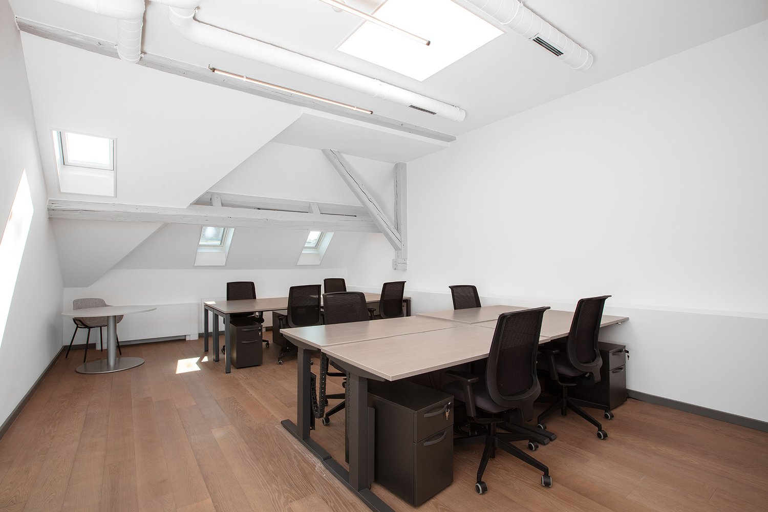 office room with tables and chairs, light fixtures, sky lights