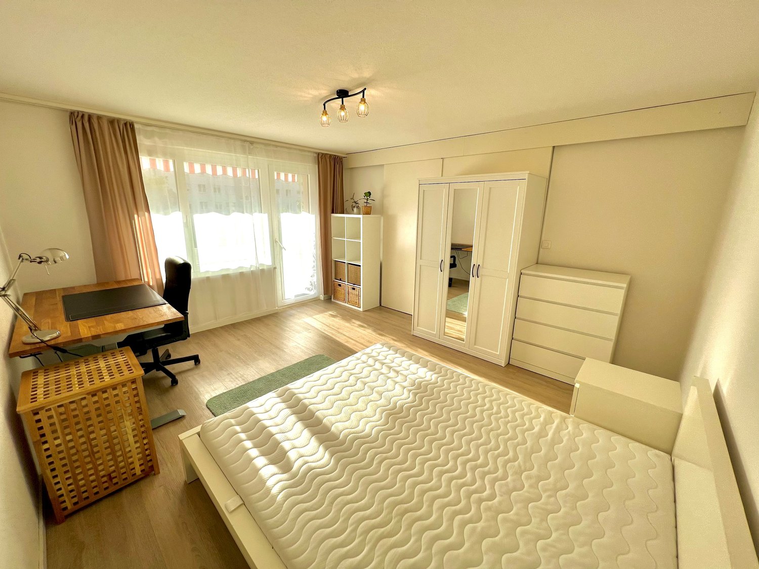 single bed, wooden desk, chair, wardrobe, lamps, windows with curtains