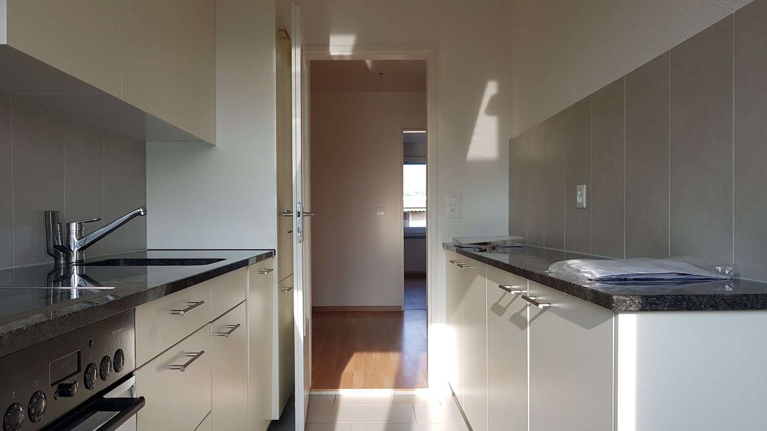 modern kitchen, white cabinets, granite countertop, stainless steel sink, gas stove