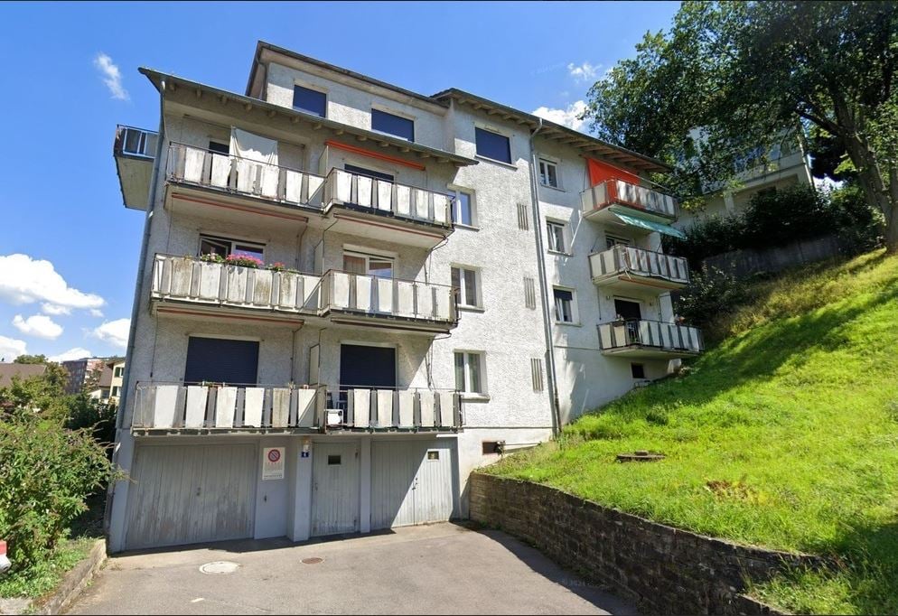 Apartment building with balconies and garages