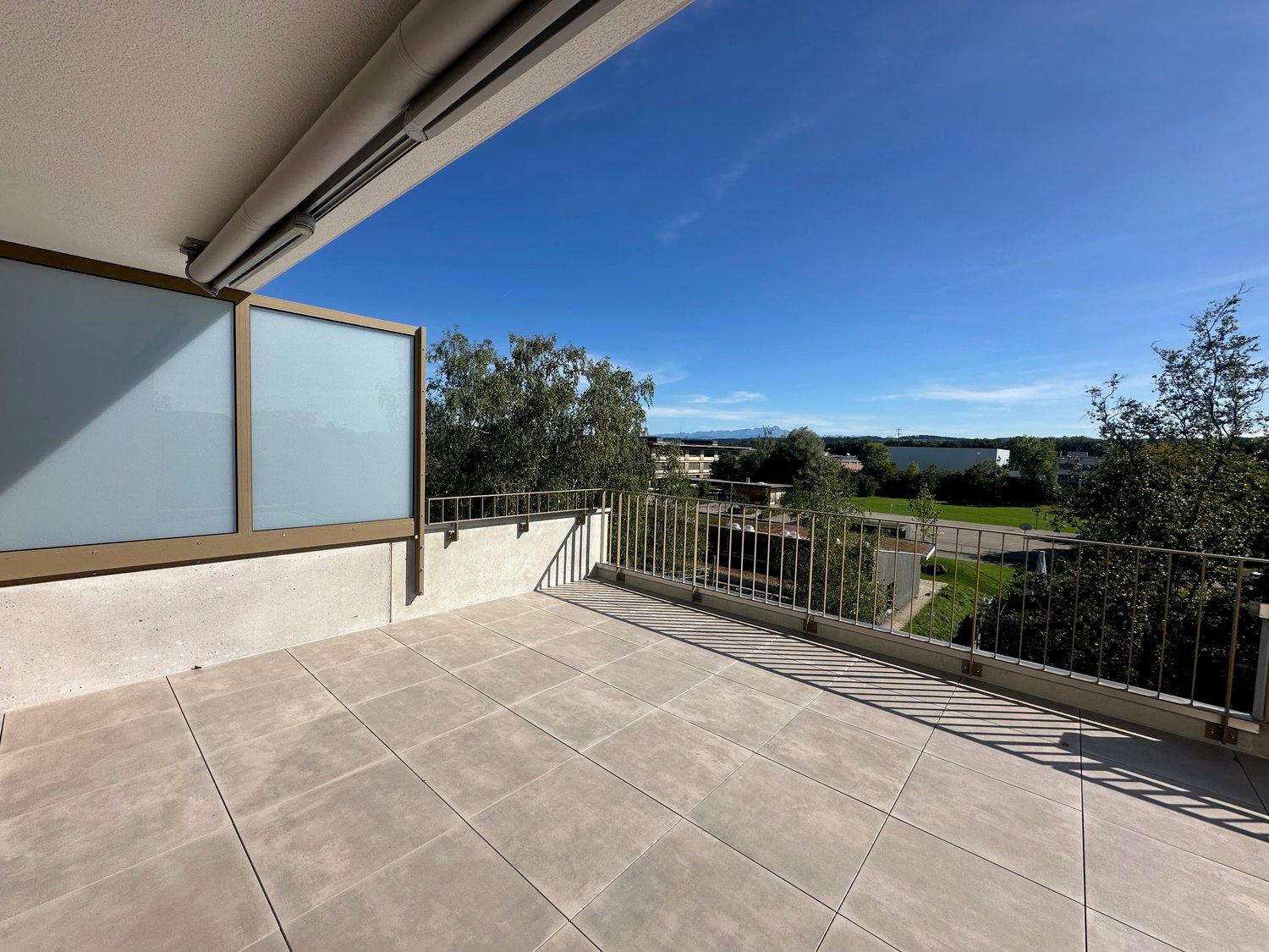 tiled floor, metal railings, city view