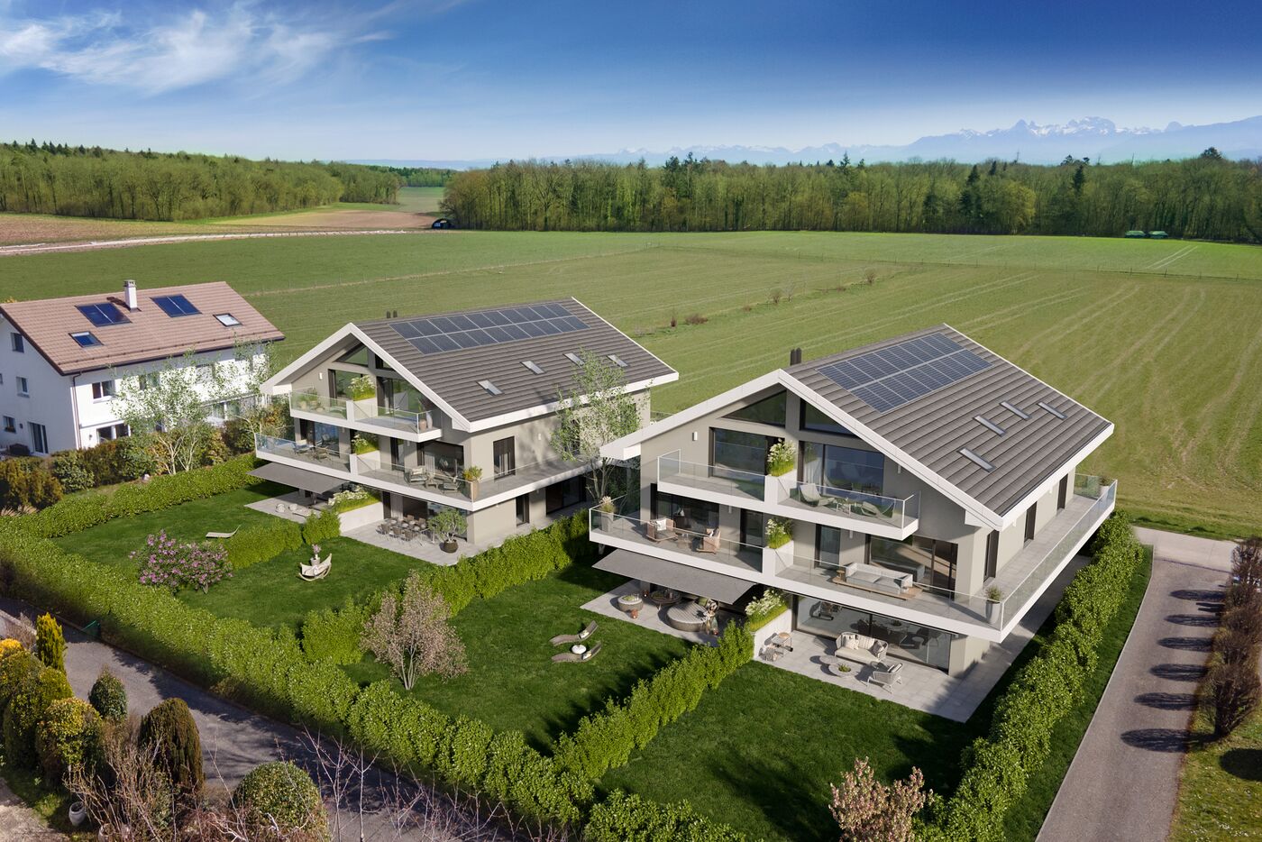 Two townhouses, 3 levels, solar panels on the roofs, balconies on each level, greenery, mountains in the background