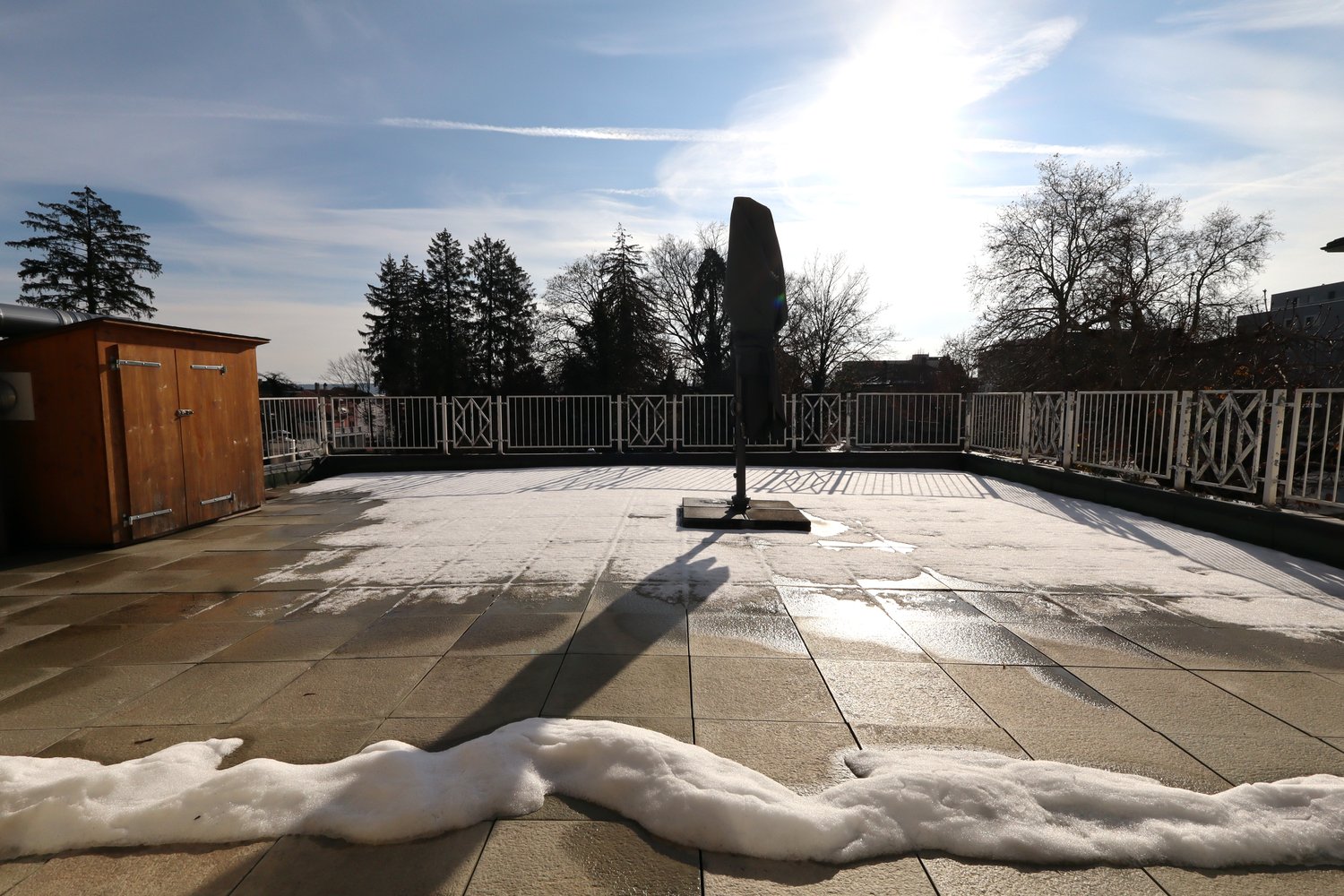 Outdoor terrace, fence, storage shed, snowy ground