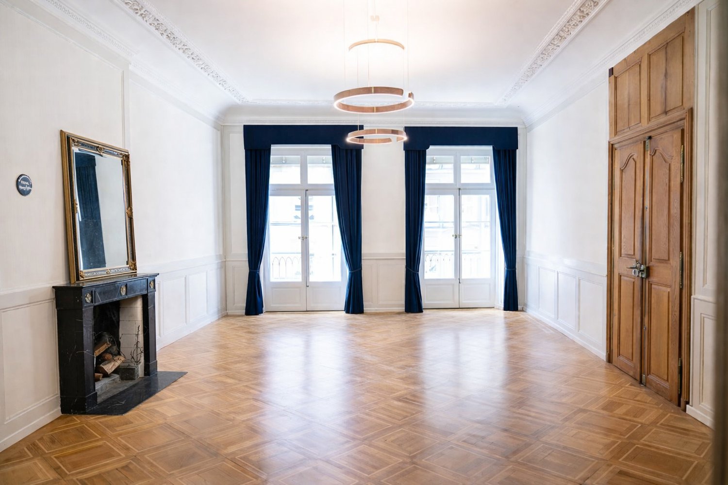 wide room, fireplace, hardwood floors, large windows, ceiling lamps