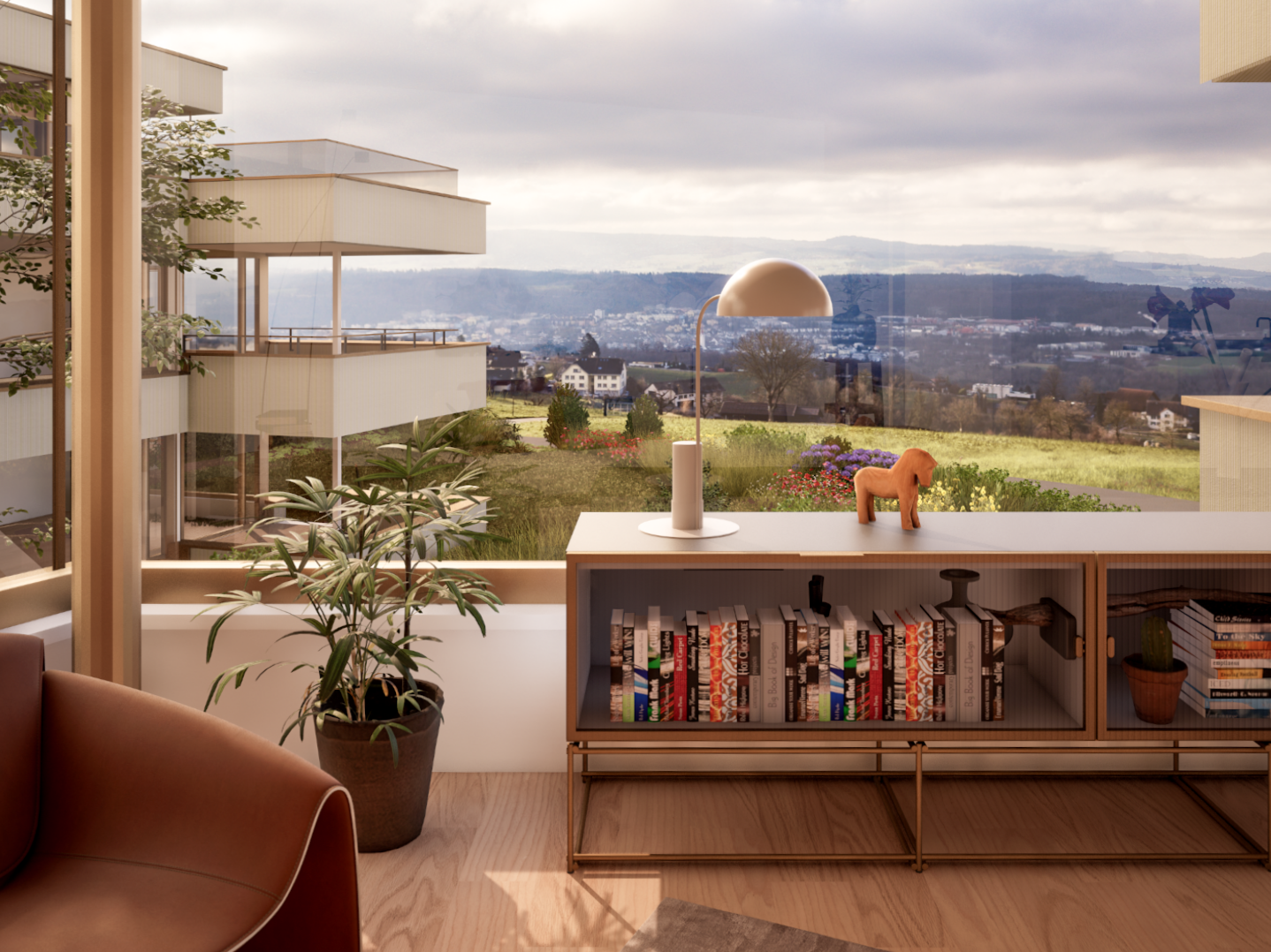 Spacious living room with large windows overlooking a scenic outdoor landscape, including a balcony or terrace. The room features a wooden bookshelf filled with books, a potted plant, and a decorative figurine on a wooden console table.
