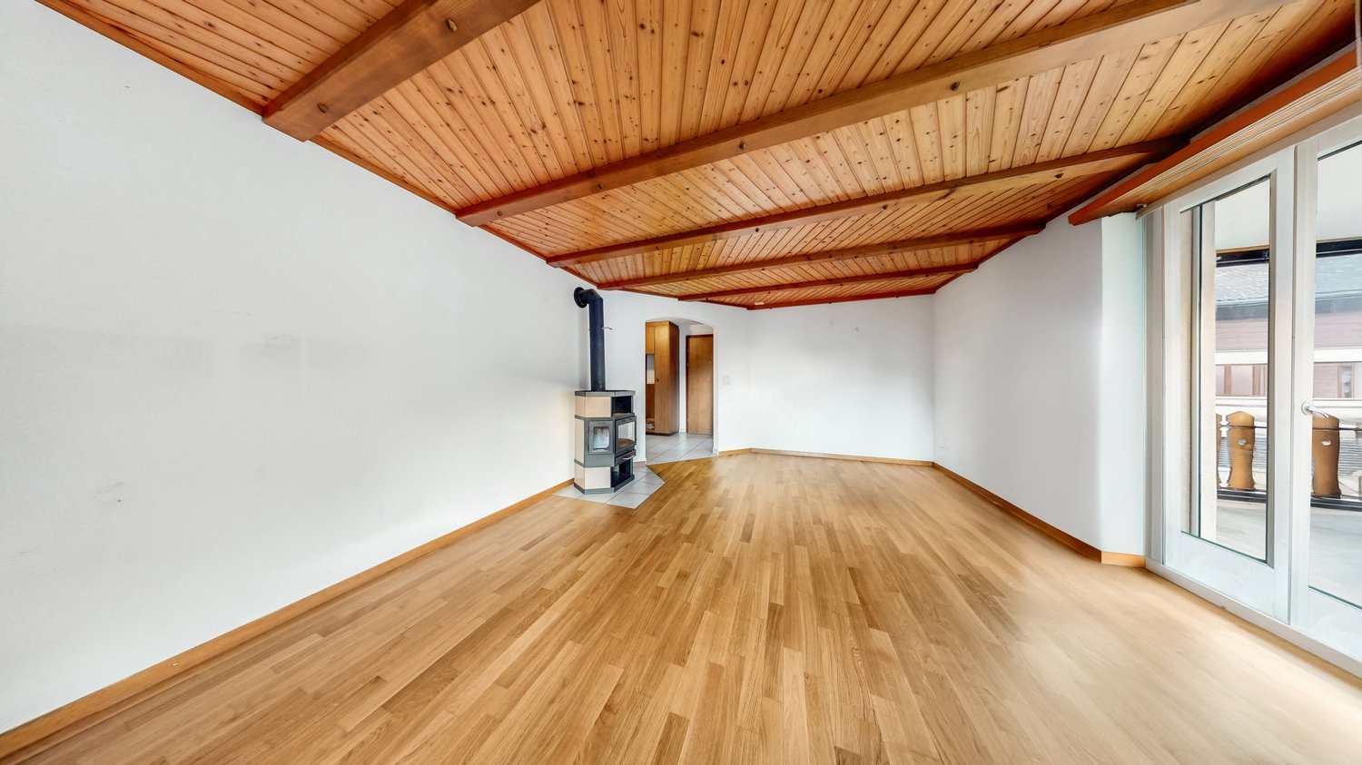 hardwood floors, wooden ceiling, white walls, fireplace, sliding glass door