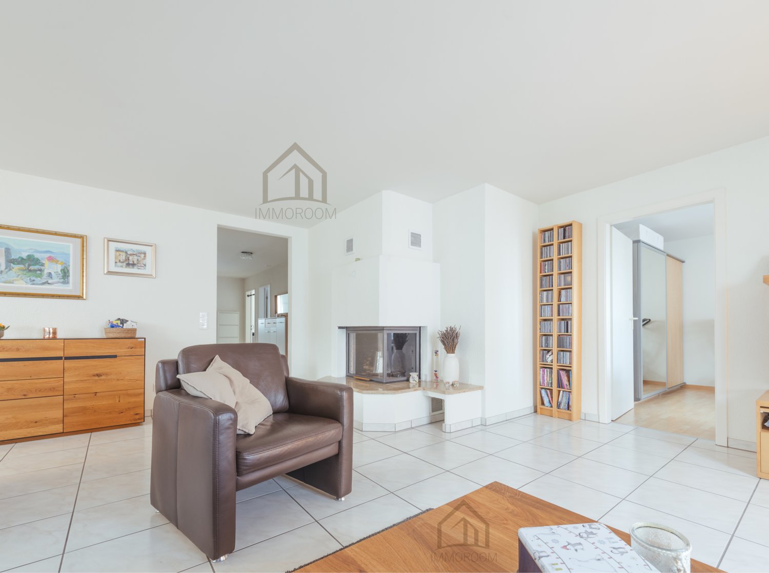 white tiled floor, fireplace, brown leather armchair, wooden cabinet, bookshelf, wooden desk