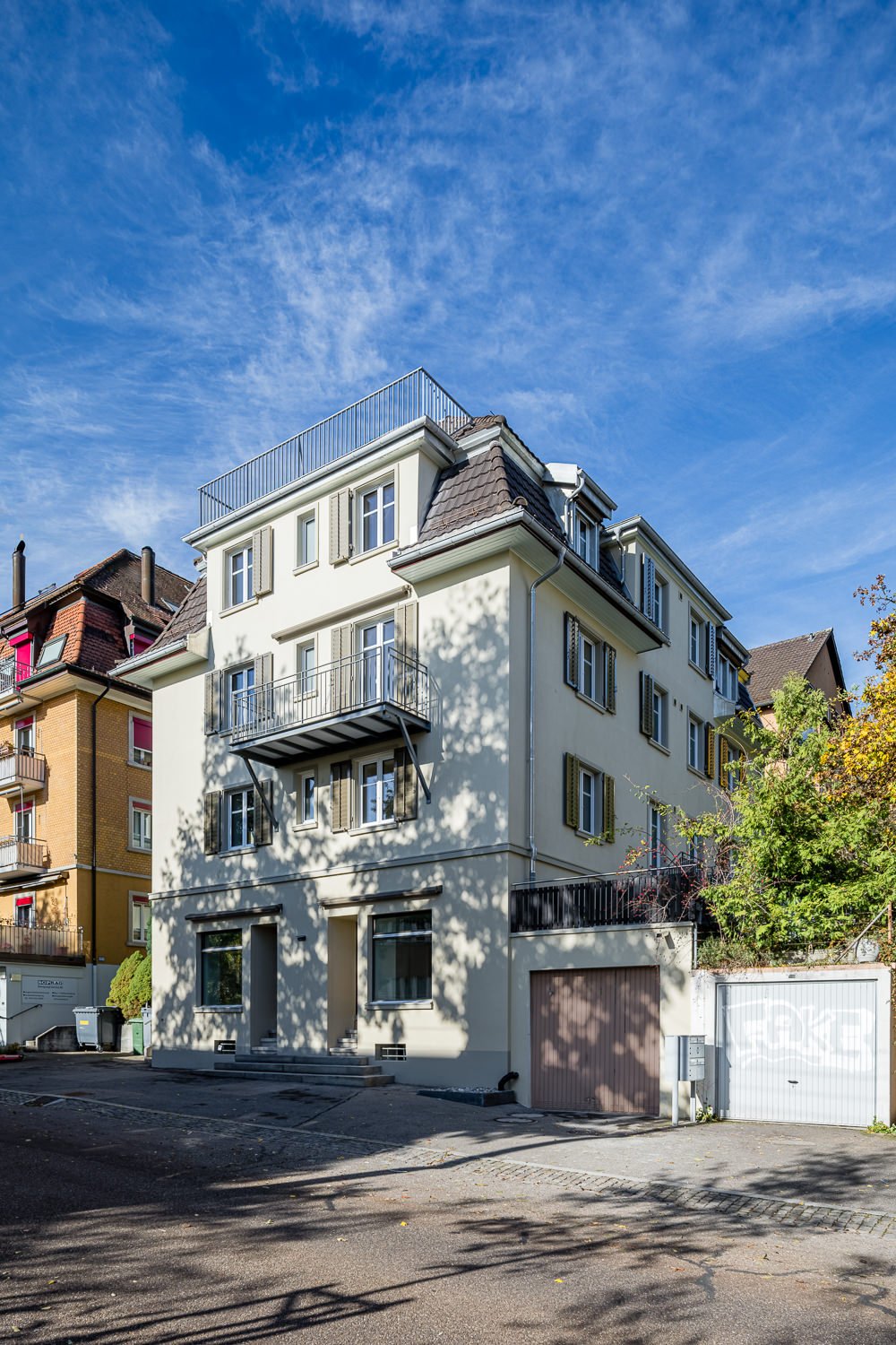 Multi-story building with multiple balconies and garages