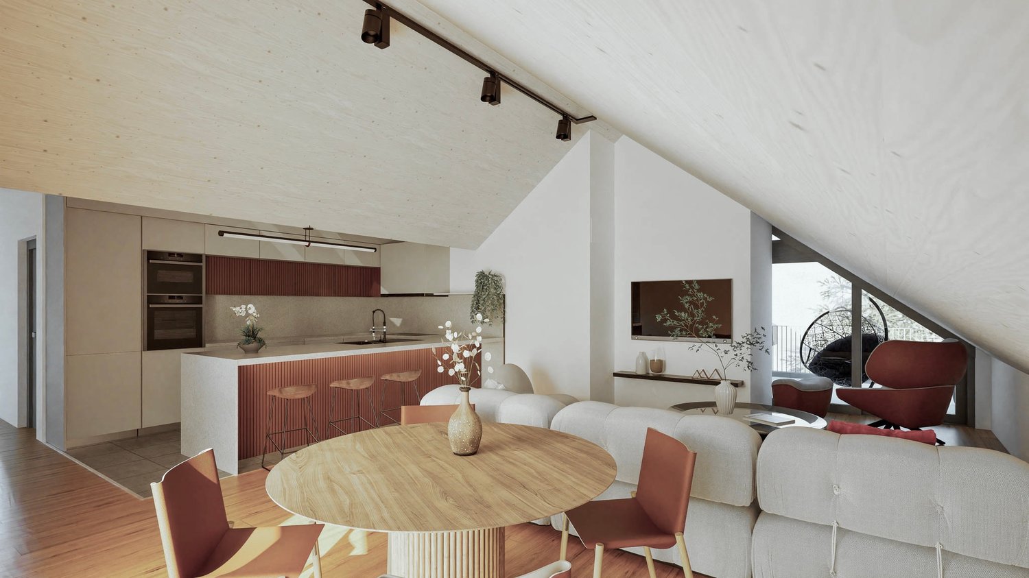 The image shows a modern, open-plan living room and kitchen area with high ceilings and large windows. The kitchen features a red and white color scheme with built-in appliances, including a dishwasher. The living room has a round wooden dining table with