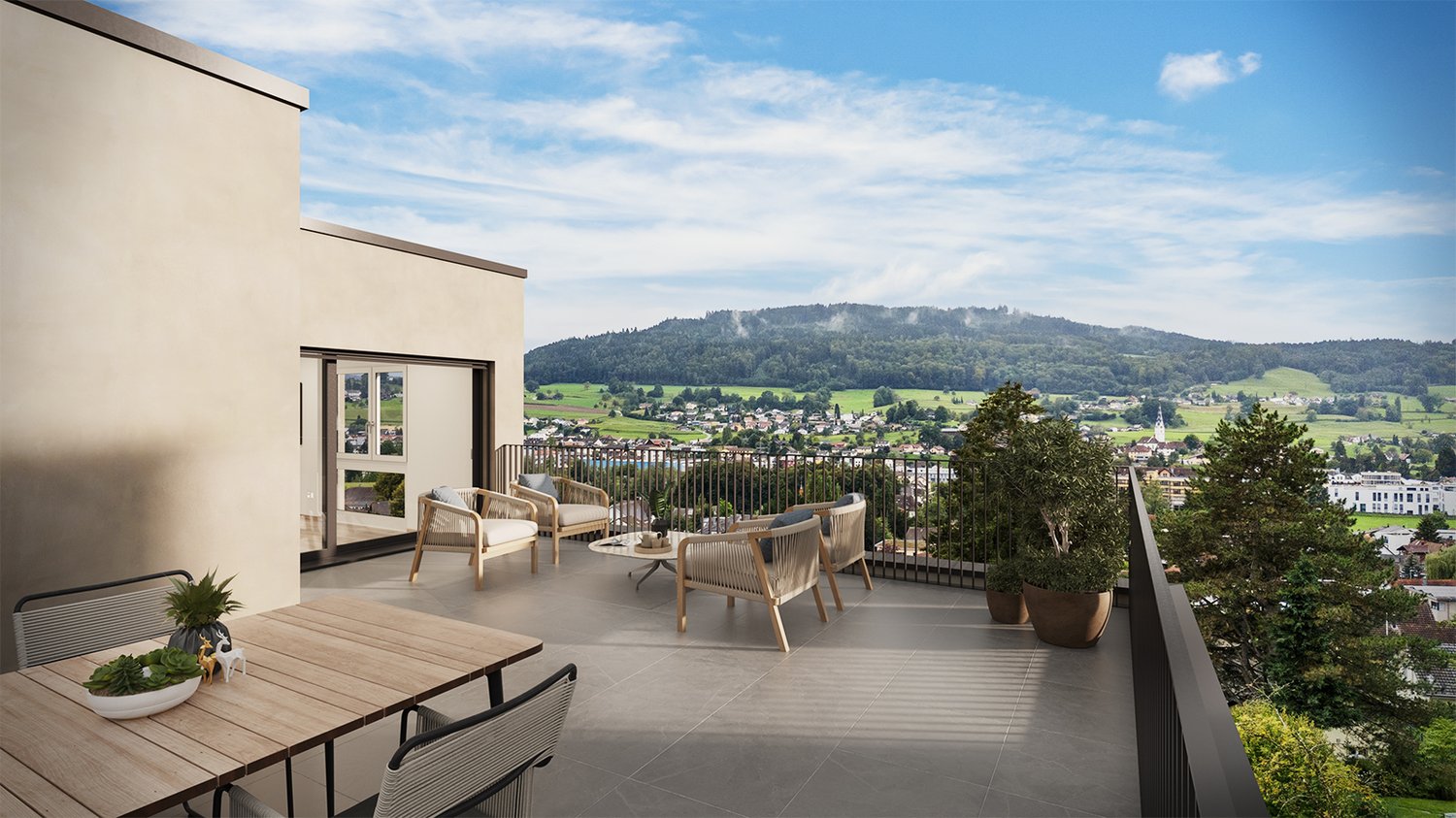 furnished seating area with outdoor table and chairs, black railing, potted plants, open glass door, distant mountain and town