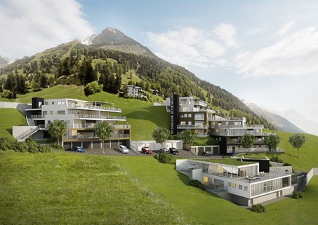 Modern building complex with multiple levels and rooftop garden, green slope, mountain backdrop, multiple parking spots, and cars parked outside.