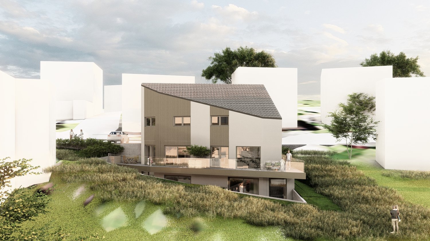 Two-story modern house with a slanted roof, wooden siding, and large windows. The house is situated on a grassy slope with trees in the background. There appears to be a balcony or terrace on the upper level.