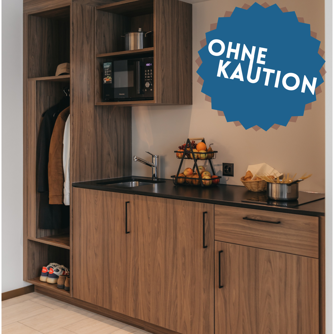 Wooden cabinets, black countertop, microwave, fruit basket, kitchen sink