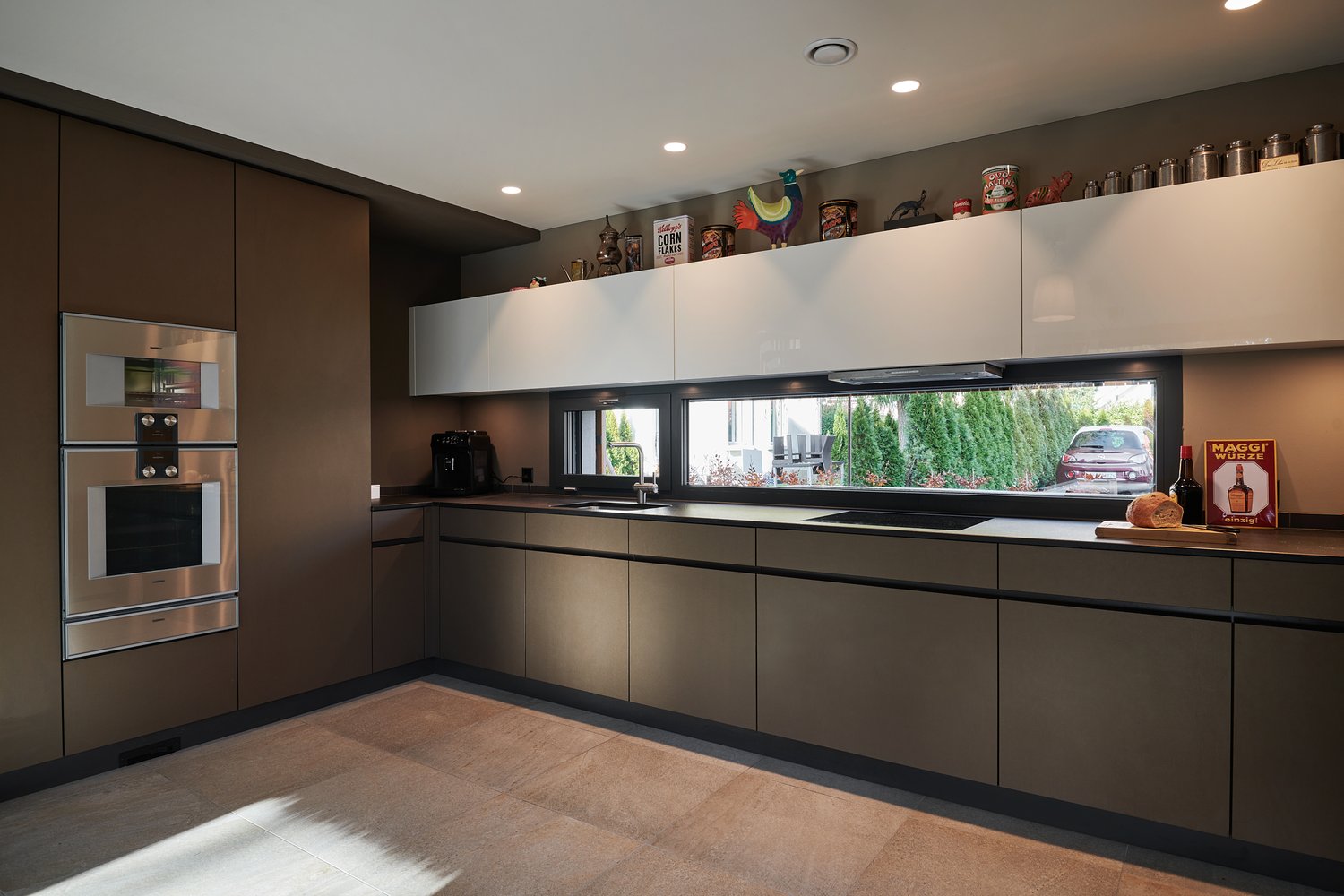 modern kitchen with white cabinetry, stainless steel appliances, tiled flooring, large windows, open shelving with decorative items