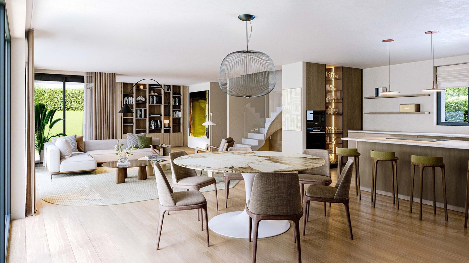 The image shows a spacious open-concept living and dining area with a large round dining table, comfortable seating, built-in shelving, and a pendant light fixture. The room has a modern and minimalist design with neutral colors and natural materials. Lar