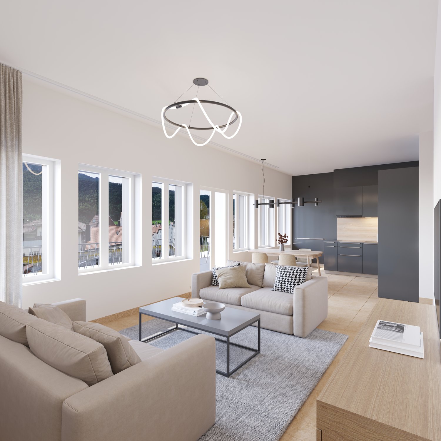 Spacious open-concept living room with large windows, modern light fixture, gray sofa and armchairs, coffee table, and kitchen area with gray cabinets and appliances