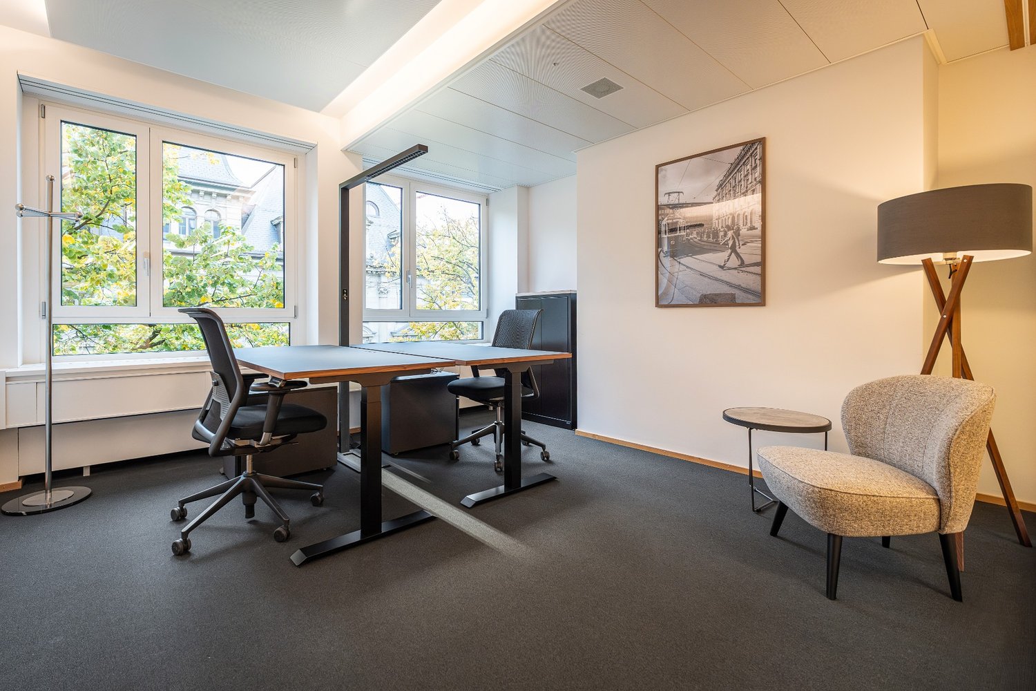 Two desks, chairs, small table, picture, lamp