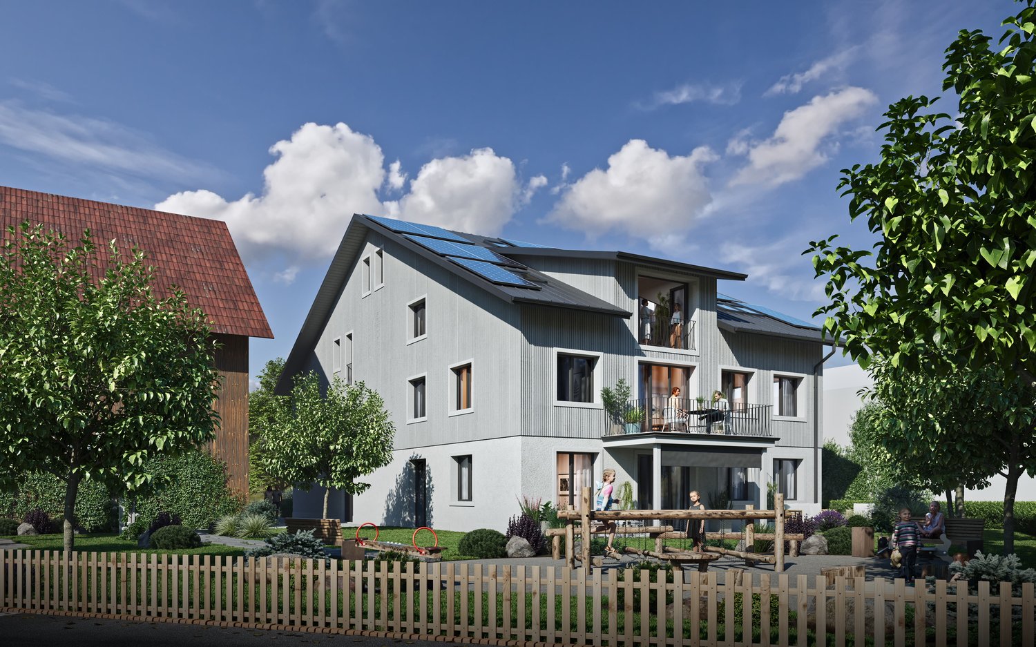 Modern house, gray walls, solar panels on the roof, balcony, wooden fence, green lawn, trees, children playing in the yard