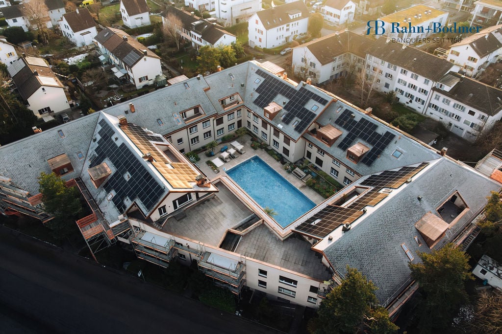 Residential building, multiple units, rooftop solar panels, central swimming pool, courtyard area
