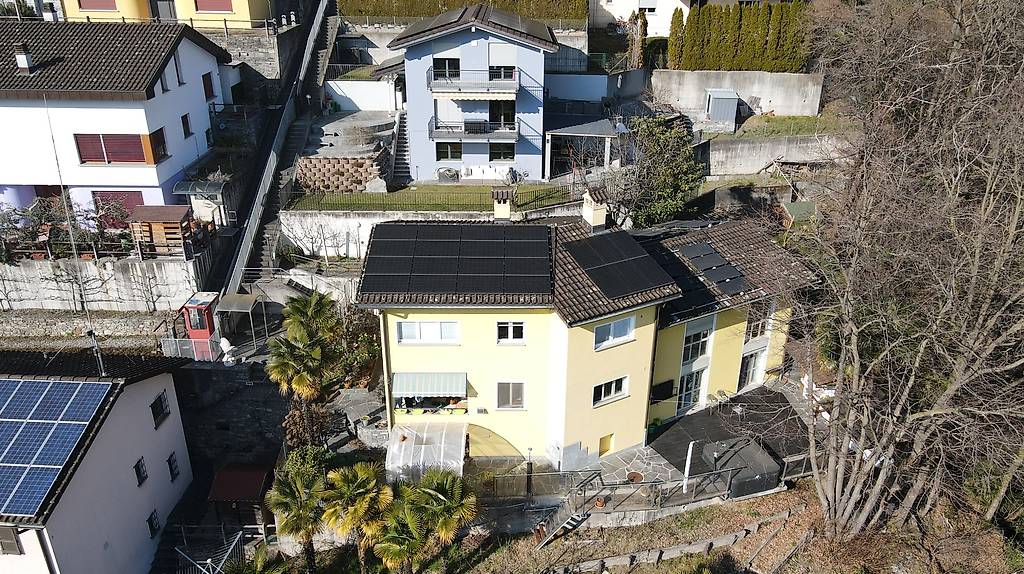 House with solar panels, elevated ground floor, backyard with pool