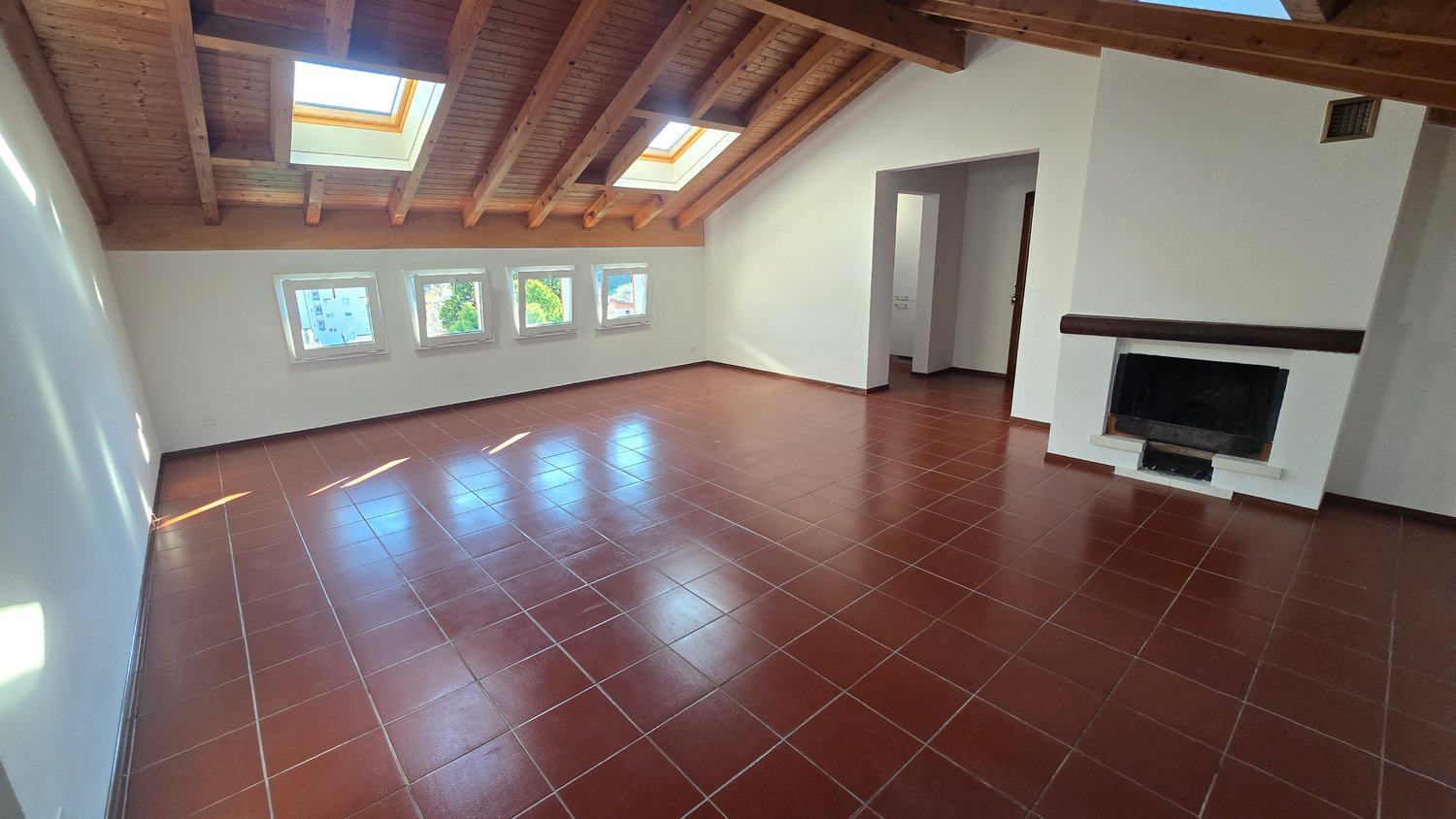 empty room, fireplace, wooden ceiling, brown tiles, windows