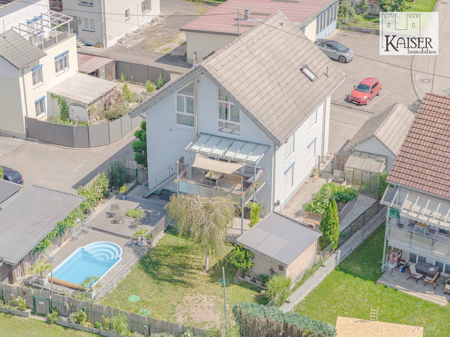 Modern house with swimming pool, large terrace, and raised ground floor.